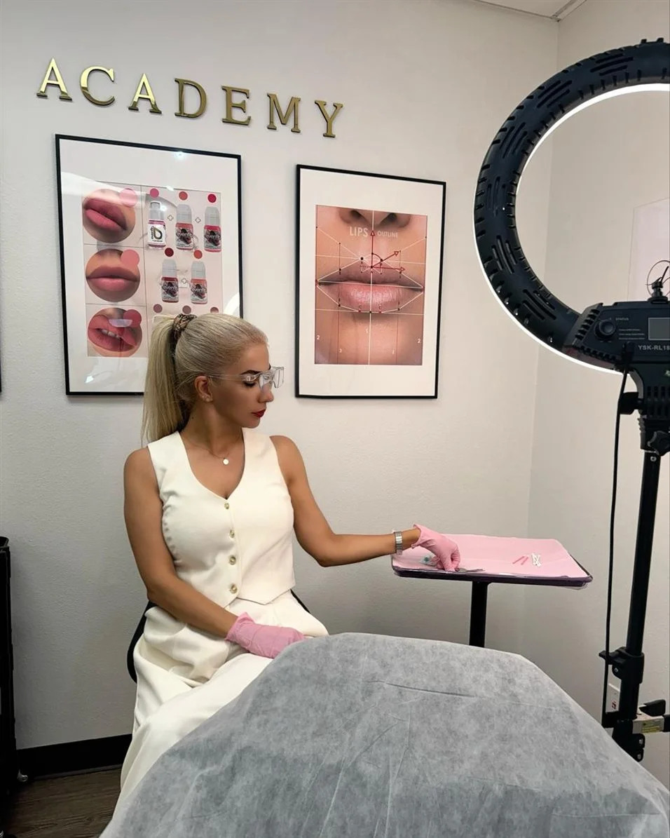 Roya seated at a prepared treatment station in the studio.